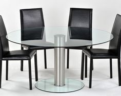 a glass table with four black chairs around it and a white wall in the background