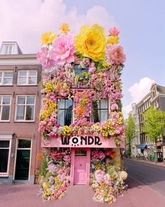 a building covered in flowers with the word wonderland written on it