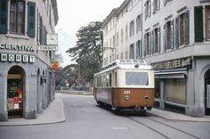 an old tram is going down the street