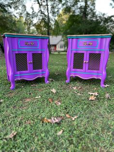 two purple and blue nightstands sitting in the grass