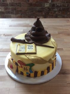 a harry potter themed birthday cake on a wooden table with a brick wall in the background