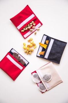 three small pouches with nuts and candy in them sitting on a table next to each other