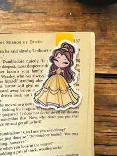 a bookmark with an image of a woman in a yellow dress on top of it