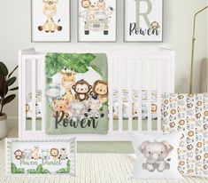 a baby's nursery room with animals and jungle prints on the wall, including a crib bedding set