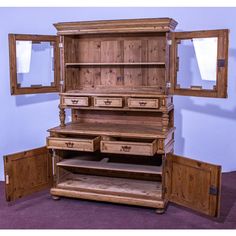 a wooden dresser with two mirrors and drawers