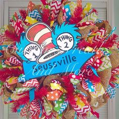 the cat in the hat wreath is hanging on the front door with it's name