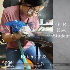 a woman in glasses is working on something with a blue object next to her and the words our new student