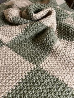 a crocheted blanket on top of a bed