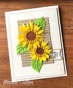 a card with sunflowers on it sitting on a table