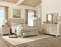 a bedroom scene with focus on the bed, dressers and mirror in the room