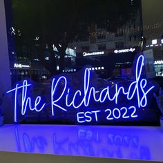 a neon sign that says the richards est 2020 on it in front of a window