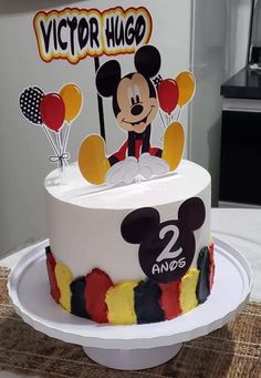 a mickey mouse birthday cake on a table