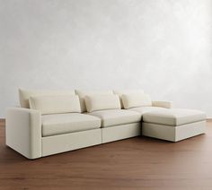 a white couch sitting on top of a wooden floor