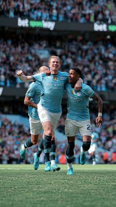 two soccer players are congratulating each other in front of an audience at a sporting event