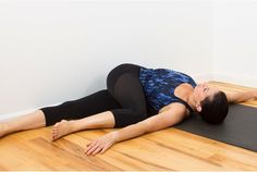 a woman is laying on the floor with her legs spread out and she is doing yoga