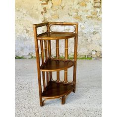 Vintage, mid-century bamboo and rattan three-tiered corner shelf on legs, from the 1960s. This beautiful piece features a design comprising a bamboo frame with curved rattan, and three triangle-shaped shelves in dark brown wood, each shelf measuring 30.5 cm wide and 24.5 cm deep. Both sides and the back of the piece feature a beautiful bentwood design, with oval/ellipsoid shapes. The rear leg is slightly curved outwards, which has been integrated into the shelf's overall design. The piece is in very good, original, vintage condition, with some light marks, signs of age and previous use commensurate with the passage of time, as well as a beautiful patina of time, on the frame, shelves, woodwork, borders and feet (see multiple photos.) The surface has only been gently cleaned and polished, i Frame Shelves, Display Cabinet Decor, Pouf Chair, Ceramic Wall Decor, Wooden Wall Shelves, Garden Table And Chairs, Wood Bookcase, Bamboo Frame, Corner Shelf