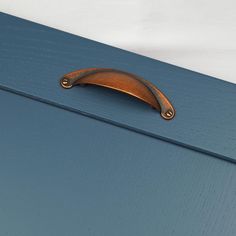 a close up of a door handle on a blue cabinet