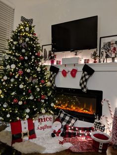 a decorated christmas tree in front of a fireplace