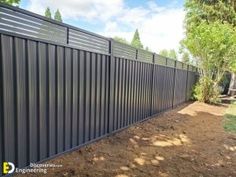 a black metal fence in the middle of a yard