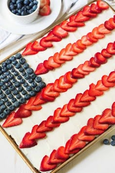 an american flag cake decorated with strawberries and blueberries