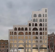 a large building with arched windows in front of it