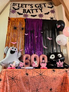 halloween decorations and balloons are displayed on a table