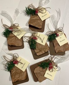 four brown tags tied with twine and holly