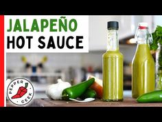 jalapeno hot sauce on a cutting board next to peppers and other vegetables