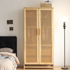 a bedroom with a bed and a wooden cabinet