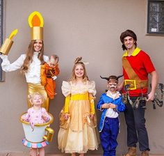 three adults and two children dressed up in costumes