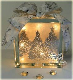 a lighted glass block with christmas trees on it