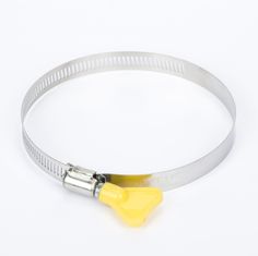 a close up of a yellow plastic object on a metal belt with a white background