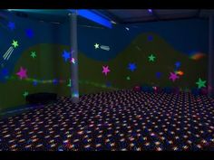 a room with stars on the wall and colorful lights in the ceiling, all around it