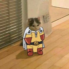 a cat is standing on the floor in front of a wall with an image of a cartoon character