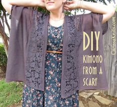 a woman standing in front of a sign with her hands on her head, wearing a dress and cardigan