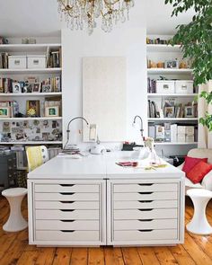 a woman sitting at a desk in front of a book shelf