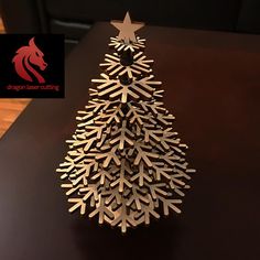 a wooden christmas tree sitting on top of a table