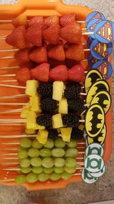 an orange plastic tray filled with fruit and veggies