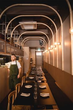 a man standing next to a table in a restaurant