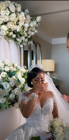 a woman in a wedding dress sitting down