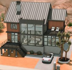 a car is parked in front of a house with a metal roof and two story windows