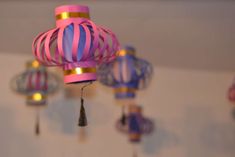 colorful paper lanterns are hanging from the ceiling