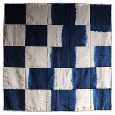 a blue and white checkerboard quilt on display