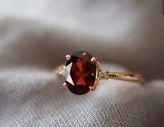 "Most Welcome to \"TheJewelryArts\" Products Description Center Stone: Genuine Garnet Center Stone Size: 6x8mm Stone Shape: Oval Cut Side Stone : Cubic Zircon Stone Clarity: VVS Material: 92.5 Sterling Silver, also available in 24k Rose Gold Vermeil/Gold Vermeil/Black Vermeil Stamp: 92.5 ➽OCCASION: Surprise your loved one with this beautiful engagement/wedding jewelry by TheJewelryArts . A classic piece of jewelry for all men/women in your life, this is a perfect gift for any occasion such as birthdays, anniversaries, wedding, engagements, Valentine's Day or Christmas day mother's day. ✔Comfort Fit ✔Nickel Free ✔Free Engraving ✔ Free Shipping ✔  Ready to Ship in 3 Business Day Customization is always welcome and please feel free to contact with me if you have any design ideas! If you have Vintage Garnet Ring, Garnet Ring Vintage, Garnet Engagement Ring, Zierlicher Ring, Bling Wedding, Garnet Jewelry, Garnet Ring, Women Ring, Ring Women