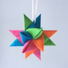 an origami star hanging from a string