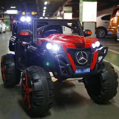 two children's toy cars in a parking garage with lights shining on the front