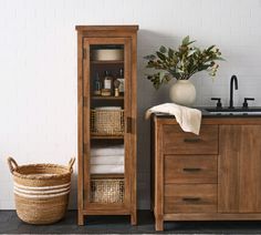 a wooden cabinet next to a sink in a bathroom