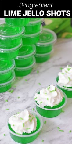 lime jello shots in plastic cups with green sprinkles on the side