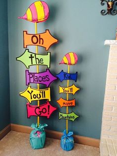 some colorful signs are hanging on the wall in a room with blue walls and carpet