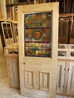 a wooden door with a stained glass window in the front and side panels behind it